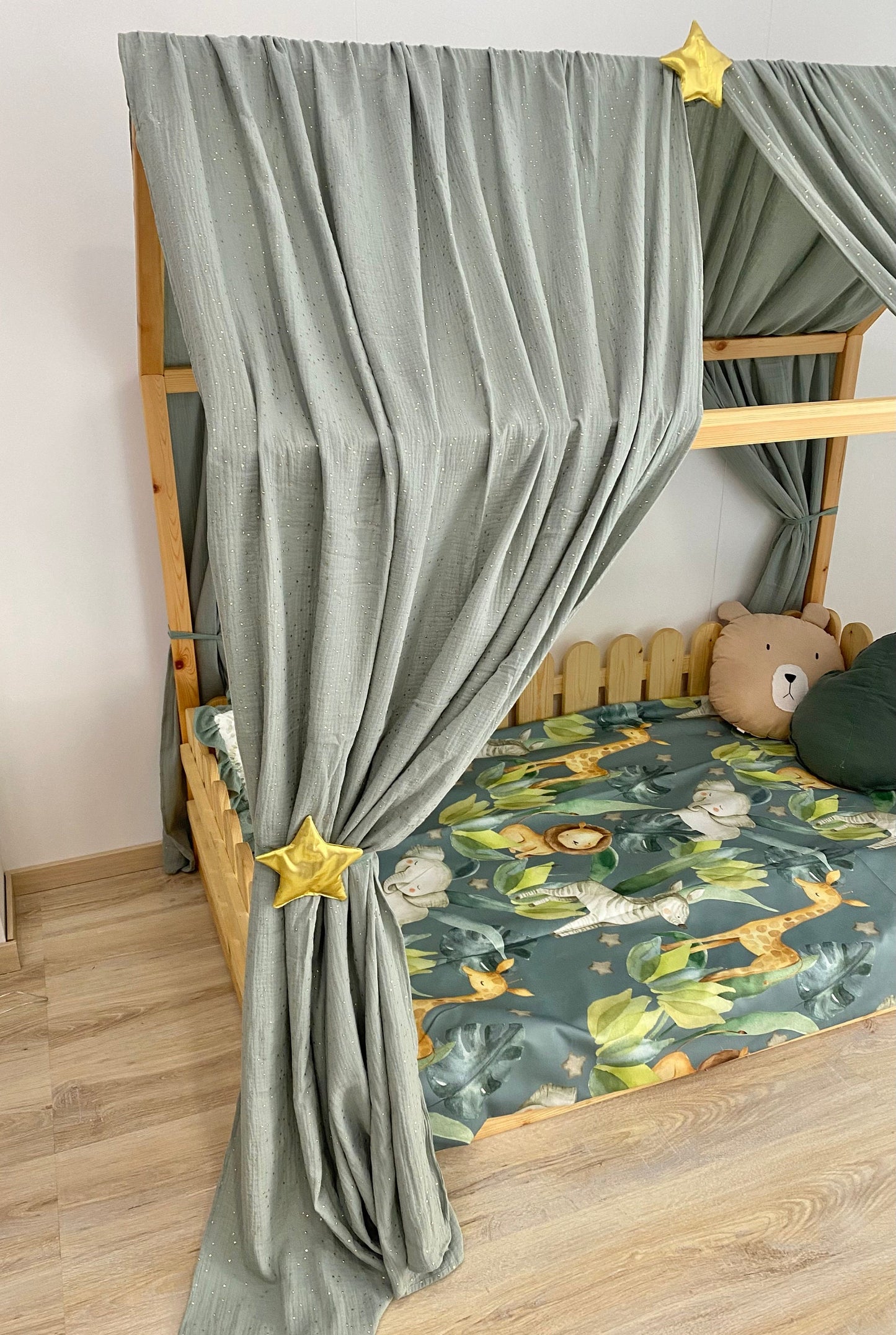 Boho kids room canopy draped around floor bed