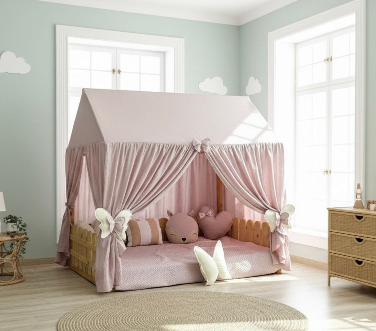 Kids’ bedroom with handmade pink muslin canopy over Montessori bed, cozy reading nook decor.
