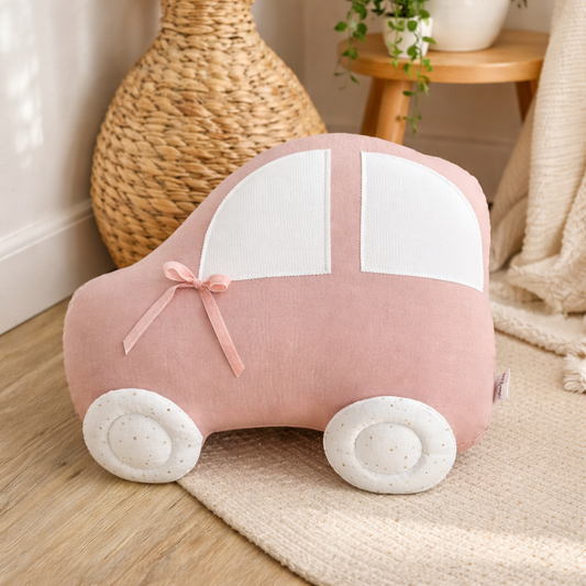 Pink handmade car shaped pillow for kids room in cotton muslin fabric with white windows and decorative bow