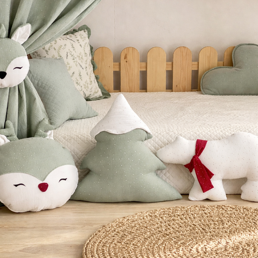 Children's room with green pillows, a wooden headboard, and stuffed animal toys.
